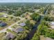 High angle aerial view of a home with a pool surrounded by lush landscapes and canal views at 485 Dorchester St, Port Charlotte, FL 33954