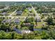 Serene aerial view showcasing a home with water access, lush greenery, and peaceful neighborhood surroundings at 485 Dorchester St, Port Charlotte, FL 33954