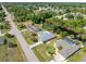 Aerial view of home, with pool, neighborhood, and lush landscaping at 485 Dorchester St, Port Charlotte, FL 33954