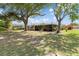Expansive backyard with mature trees offering shade and privacy, perfect for outdoor enjoyment at 485 Dorchester St, Port Charlotte, FL 33954
