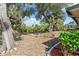 Private backyard with lush greenery, mature trees, and water views at 485 Dorchester St, Port Charlotte, FL 33954