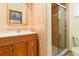 Bathroom featuring wood cabinets, tile walls, and a shower at 485 Dorchester St, Port Charlotte, FL 33954