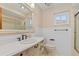 Charming bathroom featuring a vanity with marble countertop, classic fixtures, and a shower at 485 Dorchester St, Port Charlotte, FL 33954