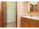 Bathroom with wood cabinets, tile floor, and a walk-in closet at 485 Dorchester St, Port Charlotte, FL 33954