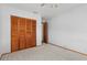 Bright bedroom with neutral carpet, ceiling fan, closet with folding doors, and an adjoining room at 485 Dorchester St, Port Charlotte, FL 33954