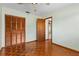 Bedroom featuring hardwood floors, a closet, and a ceiling fan at 485 Dorchester St, Port Charlotte, FL 33954