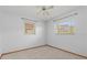 This bedroom is bright and airy with neutral carpet, ceiling fan and two windows at 485 Dorchester St, Port Charlotte, FL 33954