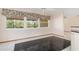 Cozy dining area with black tile floors and large windows offering serene views at 485 Dorchester St, Port Charlotte, FL 33954