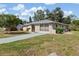 Charming single-story home featuring a well-maintained lawn, front patio, and mature landscaping at 485 Dorchester St, Port Charlotte, FL 33954
