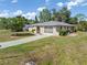 Charming single-story home with neutral colors and a well-manicured lawn and sidewalk at 485 Dorchester St, Port Charlotte, FL 33954