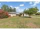 Charming single-story home featuring arched doorways and a well-maintained front yard with mature landscaping at 485 Dorchester St, Port Charlotte, FL 33954
