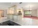 Open-concept kitchen with breakfast bar, pendant lighting, and views to the living area at 485 Dorchester St, Port Charlotte, FL 33954