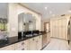 Bright, open kitchen features black counters, white cabinets, and stainless appliances at 485 Dorchester St, Port Charlotte, FL 33954