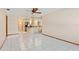 Open-concept living area with tile floors leading to the kitchen at 485 Dorchester St, Port Charlotte, FL 33954