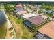 Aerial shot of homes with screened pools, near a golf course and lake in a lush community at 5461 White Ibis Dr, North Port, FL 34287