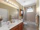 Bright bathroom with a double sink vanity, tub and shower combo, and great storage at 5461 White Ibis Dr, North Port, FL 34287