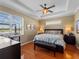 Comfortable bedroom with wood floors, tray ceilings, and bright windows at 5461 White Ibis Dr, North Port, FL 34287