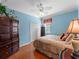 Comfortable bedroom featuring a ceiling fan, closet, and dark wood flooring at 5461 White Ibis Dr, North Port, FL 34287
