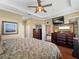 Bedroom with wood floors, tray ceiling, and multiple access doors at 5461 White Ibis Dr, North Port, FL 34287
