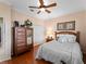 Charming bedroom with light walls, ceiling fan, and hardwood floors at 5461 White Ibis Dr, North Port, FL 34287
