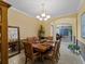 Well-appointed dining room featuring a traditional chandelier, wooden table, and decor at 5461 White Ibis Dr, North Port, FL 34287