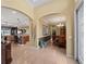Inviting entryway featuring arched doorways leading to the kitchen, dining room, and living area at 5461 White Ibis Dr, North Port, FL 34287
