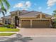 Charming home with a three-car garage, a paver driveway, and well-maintained landscaping at 5461 White Ibis Dr, North Port, FL 34287