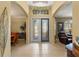 Grand foyer with tile flooring, high ceilings, decorative glass doors, and views into living areas at 5461 White Ibis Dr, North Port, FL 34287