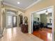 Inviting foyer with tile floors leads to a home office and offers views of the living spaces at 5461 White Ibis Dr, North Port, FL 34287