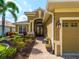 Inviting front entrance with manicured landscaping, a brick walkway, and double front doors at 5461 White Ibis Dr, North Port, FL 34287