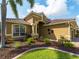 Charming home exterior with lush landscaping, a well-manicured lawn, and a beautiful entrance at 5461 White Ibis Dr, North Port, FL 34287