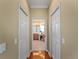 Hallway view of the wood flooring and access to closets and the bathroom at 5461 White Ibis Dr, North Port, FL 34287
