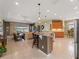 Open kitchen with granite island and barstool seating seamlessly connects with the living area and lake views at 5461 White Ibis Dr, North Port, FL 34287