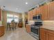 Bright kitchen with stainless appliances, tile floors, and a breakfast nook at 5461 White Ibis Dr, North Port, FL 34287
