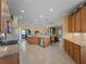 Spacious kitchen with stainless steel appliances and granite countertops offers seamless flow into living area at 5461 White Ibis Dr, North Port, FL 34287