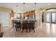 Open kitchen with tile flooring, granite countertops, and breakfast bar at 5461 White Ibis Dr, North Port, FL 34287