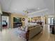 Open-concept living room with tile floors, ceiling fan and seamless flow to kitchen and dining area at 5461 White Ibis Dr, North Port, FL 34287