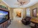 Inviting living room with a leather recliner, media center, and a clear view of the dining room at 5461 White Ibis Dr, North Port, FL 34287