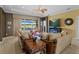 Cozy living room with access to pool and golf course views, complemented by a decorative ceiling fan at 5461 White Ibis Dr, North Port, FL 34287