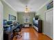 Home office with hardwood floors, a ceiling fan, and ample space for dual desks at 5461 White Ibis Dr, North Port, FL 34287