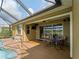 Covered lanai features a ceiling fan, outdoor speakers, and a view of the golf course at 5461 White Ibis Dr, North Port, FL 34287