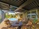 Enclosed patio with a pool view, comfortable seating, and a fire pit for relaxation and socializing at 5461 White Ibis Dr, North Port, FL 34287