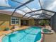 Inviting pool area with a spa, covered patio, and views of the golf course at 5461 White Ibis Dr, North Port, FL 34287