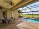 Screened-in pool area with a covered patio and an outdoor dining set overlooking a golf course at 5461 White Ibis Dr, North Port, FL 34287
