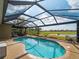 Beautiful pool area with a spa, seating, and views of the golf course and lake at 5461 White Ibis Dr, North Port, FL 34287