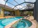 Beautiful screened-in pool and spa area with a view at 5461 White Ibis Dr, North Port, FL 34287