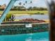 Inviting in-ground pool area features a decorative tile border and view of the golf course at 5461 White Ibis Dr, North Port, FL 34287
