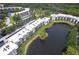 Aerial view of condo community with lake and mature trees surrounding the buildings at 6070 80Th N St # 215, St Petersburg, FL 33709