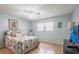 Bedroom featuring a queen bed, ceiling fan, laminate floors, and a flat screen TV at 6070 80Th N St # 215, St Petersburg, FL 33709