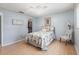 Bedroom with a queen bed, ceiling fan, laminate floors, and a walk-in closet at 6070 80Th N St # 215, St Petersburg, FL 33709